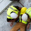 Two Construction Workers Helping Injured Worker
