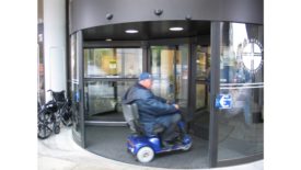 Person Riding Wheelchair Through Revolving Door