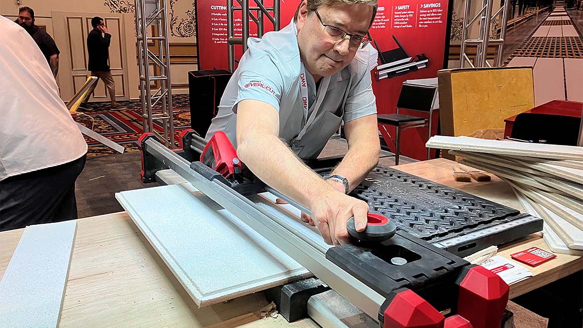 A man cutting ceiling tile