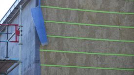 Fiberglass Z-girts (green) installed horizontally, with rainscreen (blue) and wire lath installed vertically.