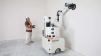 A man standing next to a drywall finishing machine