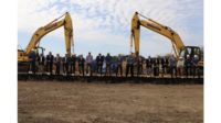 People Standing in Front of Bulldozers