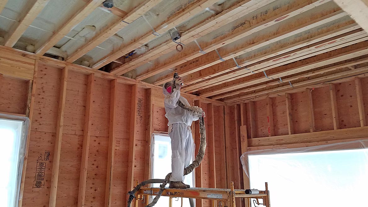 Subcontractors installing insulation and drywall