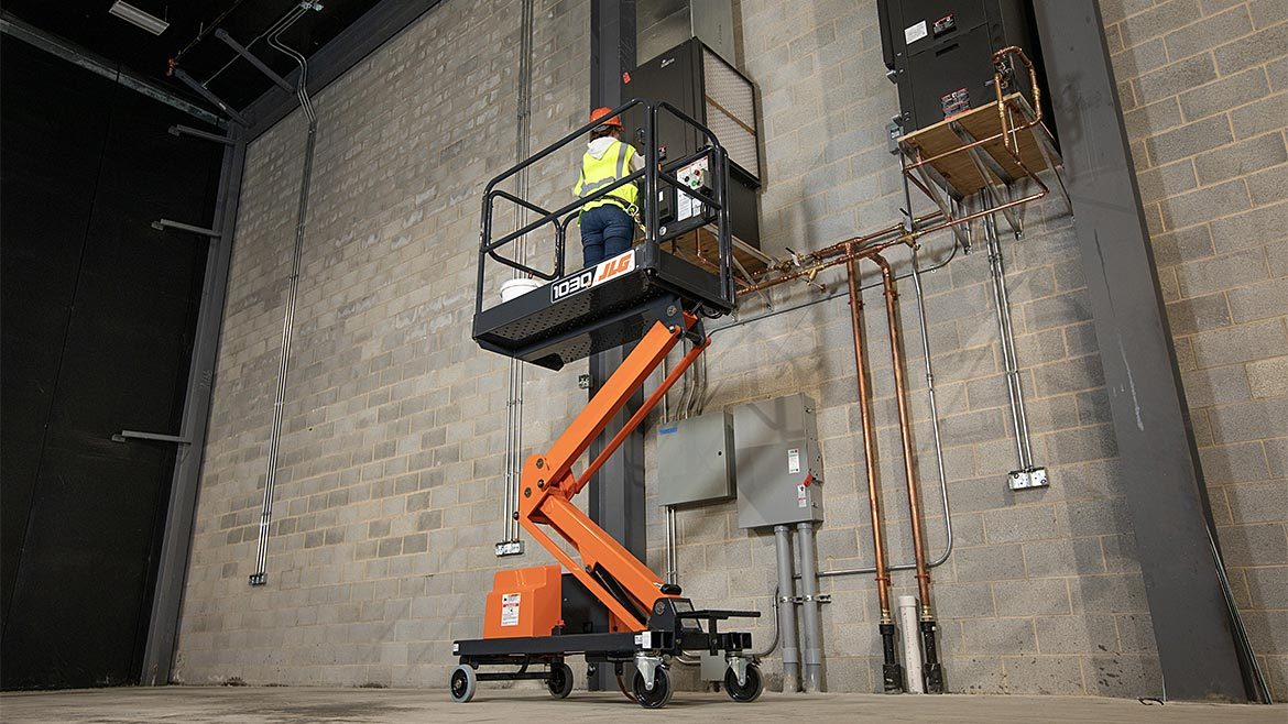 A worker using an aerial lift