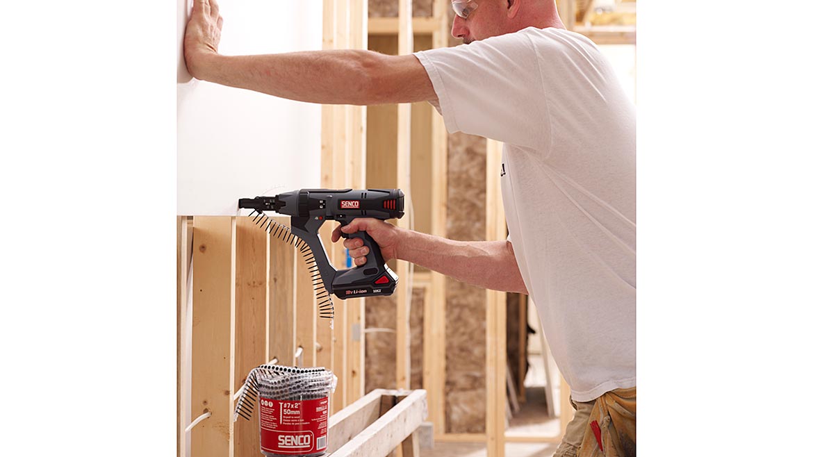 A SENCO screwgun being used to install drywall