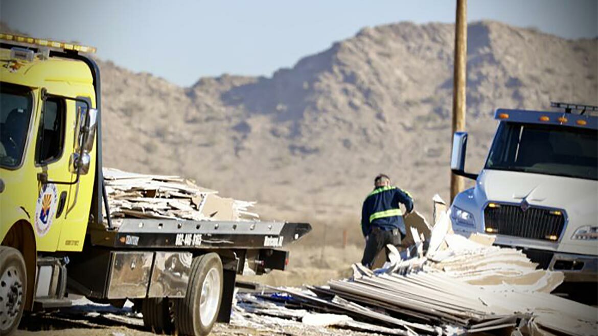 Tow truckers clear drywall from the median on State Route 347